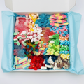 Sweet box with rainbow mix sweets and blue tissue paper